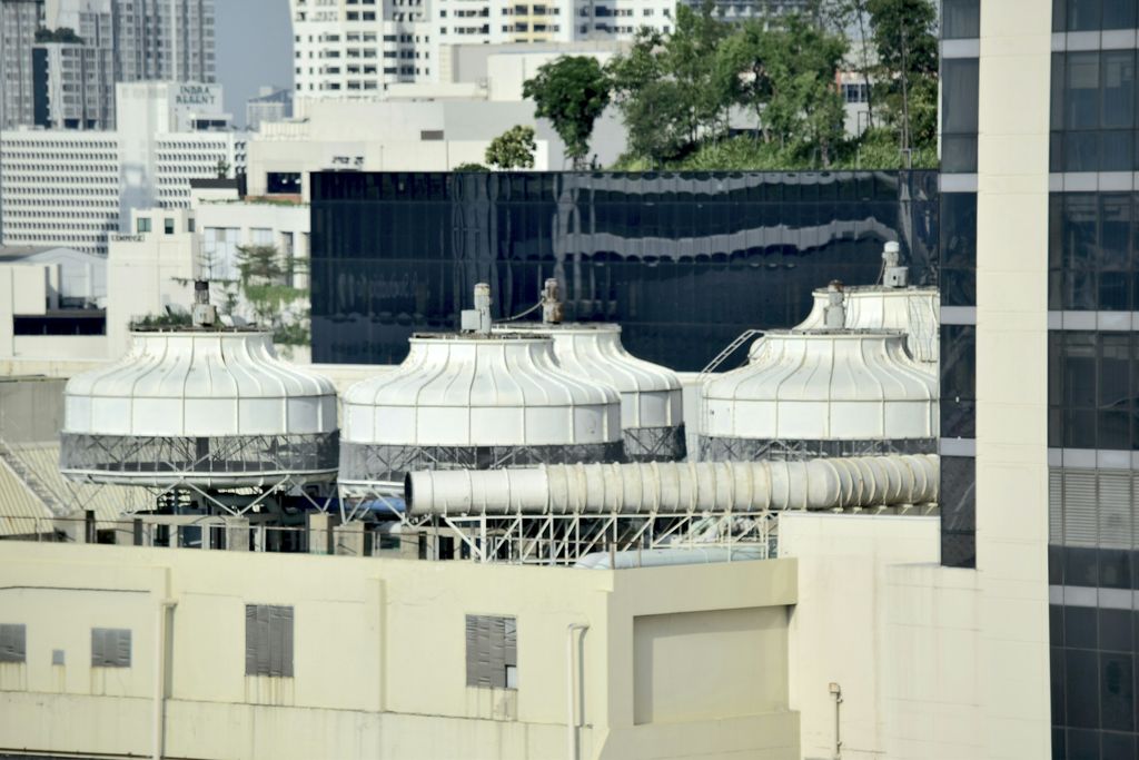 Round cooling towers on the roof of a city building