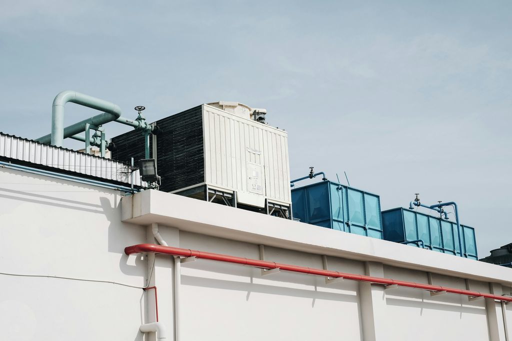 Cooling tower and water tanks along the edge of a commercial roof